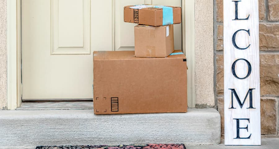 Deliveries on the front porch of a house with a welcome sign in Albany